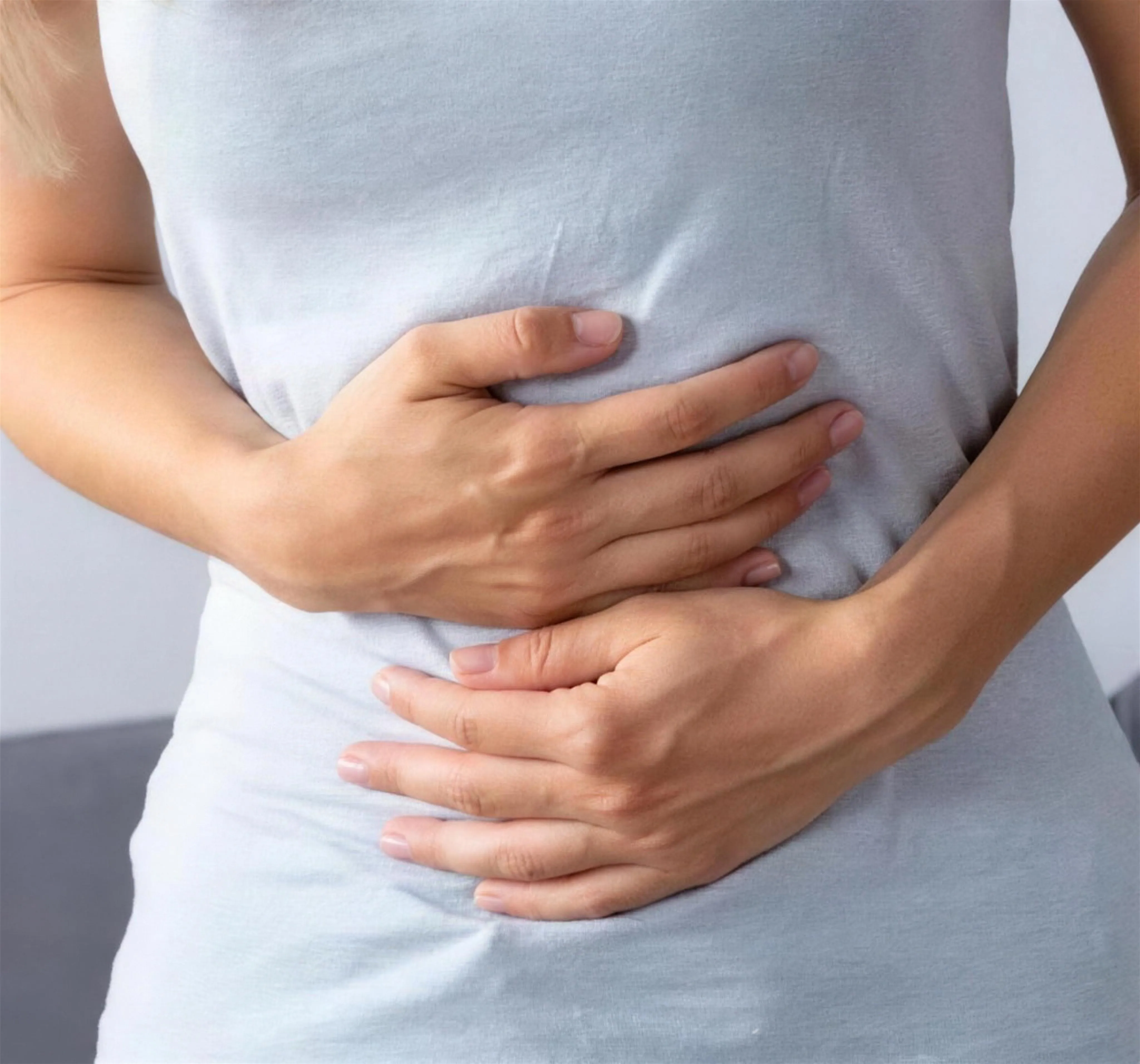 Woman holding her stomach with abdominal discomfort